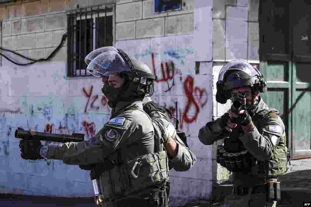 Israeli security forces fire tear gas during clashes in the Wadi Joz neighborhood of Israeli-annexed east Jerusalem, amid the ongoing conflict between Israel and the Palestinian militant group Hamas.