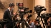 FILE - A videographer with China Media Group (CMG) films during a press conference at the Great Hall of the People in Beijing, March 4, 2023. Indonesian network Metro TV signed an agreement with CMG in November 2023 to expand some of its content.