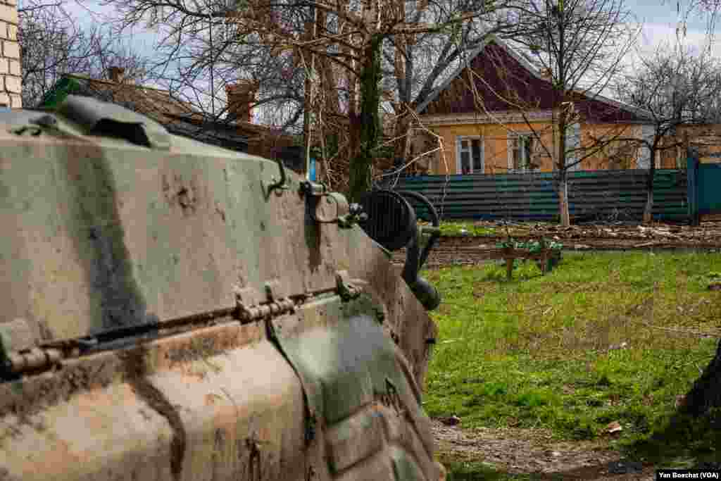 An armored personal carrier was parked just a few meters from the graves of two people who were killed last summer, April 4, 2023.