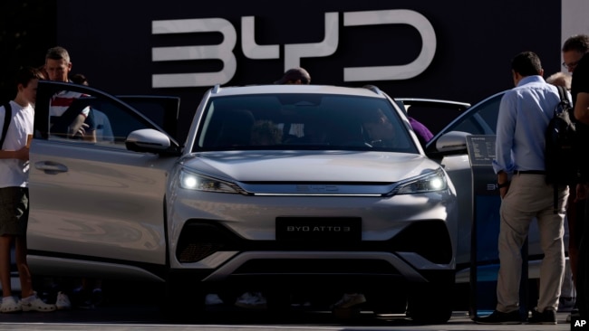 FILE - Visitors check out the China-made BYD ATTO 3 at the IAA motor show in Munich, Germany, Sept. 8, 2023. Chinese automakers are winning over drivers as they make major inroads into Europe’s electric vehicle market, challenging long-established brands.