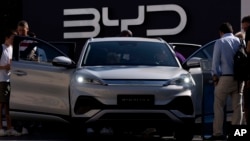 FILE - Visitors examine the China-made BYD ATTO 3 at the IAA motor show in Munich, Germany, Sept. 8, 2023. Myanmar's drivers are shifting to electric vehicles, a move that underscores the military junta's growing ties with China, where most EVs and component parts are made.