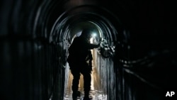 Lt. Col. Ido, whose last name was redacted, walks inside a tunnel underneath the UNRWA compound, where the military discovered tunnels in the main headquarters of the UN agency during a ground operation in Gaza, Feb. 8, 2024.