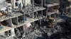 Palestinians look at the destruction after an Israeli strike on residential buildings and a mosque in Rafah, Gaza Strip, Thursday, Feb. 22, 2024.