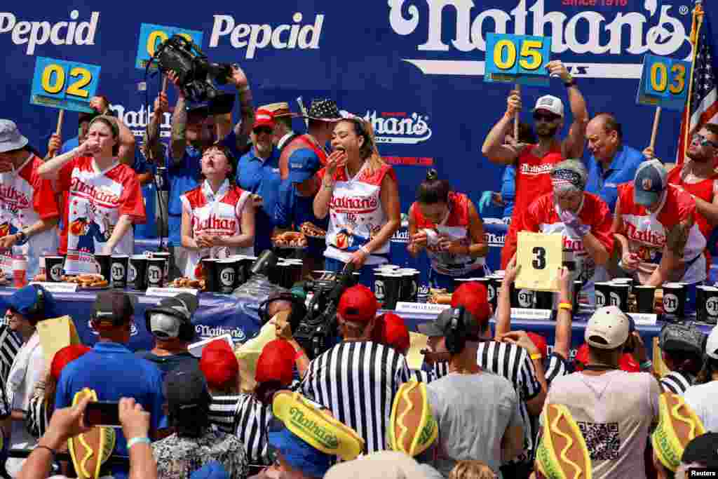 People compete in the 2023 Nathan's Famous Fourth of July International Hot Dog Eating Contest at Coney Island in New York City, July 4, 2023. 