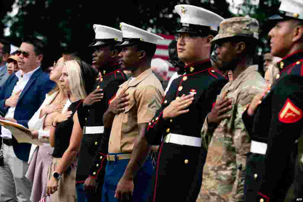 New U.S. citizens recite the Pledge of Allegiance after being sworn in during a naturalization ceremony on Independence Day at George Washington's Mount Vernon in Mount Vernon, Virginia, July 4, 2023.