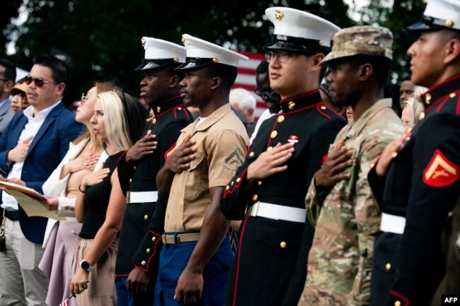 FILE - New U.S. citizens recite the Pledge of Allegiance after being sworn in during a naturalization ceremony on Independence Day at George Washington's Mount Vernon in Mount Vernon, Virginia, July 4, 2023. (Photo by Stefani Reynolds / AFP)