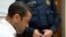 FILE - Brazilian soccer star Dani Alves sits during his trial in Barcelona, Spain, Feb. 5, 2024. Alves has been found guilty on Feb. 22, 2024 of sexually assaulting a young woman in a Barcelona nightclub.