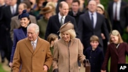 FILE — Britain's King Charles III and Queen Camilla arrive to attend the Christmas day service at St. Mary Magdalene Church in Sandringham in Norfolk, England, Dec. 25, 2023.