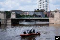 An armed security patrol moves in the Milwaukee near the Fiserv Forum during the first day of the 2024 Republican National Convention, July 15, 2024, in Milwaukee.