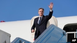 U.S. Secretary of State Antony Blinken waves as he boards his plane at an airport in Tel Aviv, Israel, Feb. 8, 2024.