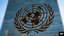 FILE - The symbol of the United Nations is displayed outside the Secretariat Building, Feb. 28, 2022, at United Nations Headquarters. The U.N. has been working on a global cybercrime treaty but there are concerns about the treaty's broad language. 