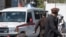 An ambulance carries victims from near the site of a suicide attack in Kabul on March 27, 2023. 