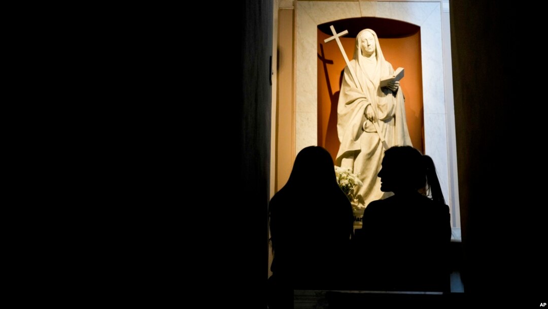Florencia Pittaluga, right, and Maria Eugencia Iturriza visit the tomb of María Antonia de Paz y Figueroa, more commonly known by her Quechua name of 'Mama Antula,' at the Nuestra Senora de la Piedad Basilica, in Buenos Aires, Argentina, Jan. 30, 2024. 