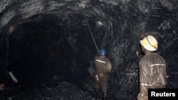 FILE — Mine workers are pictured at the Freda Rebecca gold mine in Bindura town February 7, 2015. 