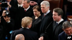 Then-President Donald Trump greets Supreme Court Justices Brett Kavanaugh (second right) and Neil Gorsuch (third right), two of the three justices he appointed during his time in office, Feb. 5, 2019.