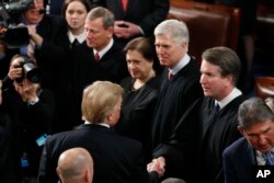Former President Donald Trump greets Supreme Court Justices Brett Kavanaugh (second right) and Neil Gorsuch (third right), two of the three justices he appointed during his term, Feb. 5, 2019.
