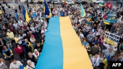 In this aerial view pro-Ukraine demonstrators take part in a rally commemorating the second anniversary of the Russian invasion of Ukraine at the Obelisk in Buenos Aires, Argentina, Feb. 24, 2024.