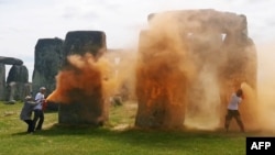 An image grab from a video released by the Just Stop Oil climate campaign group shows activists spraying an orange substance at Stonehenge in Wiltshire, southwest England.