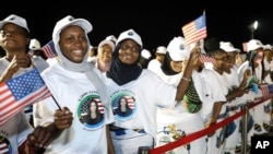 People welcome U.S. Vice President Kamala Harris on her arrival at Julius Nyerere Airport in Dar es Salaam, Tanzania, March 29, 2023.