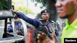 A police officer reacts during a protest near the UN mission in Congo MONUSCO headquarters in downtown Kinshasa, Democratic Republic of Congo, Feb. 12, 2024.