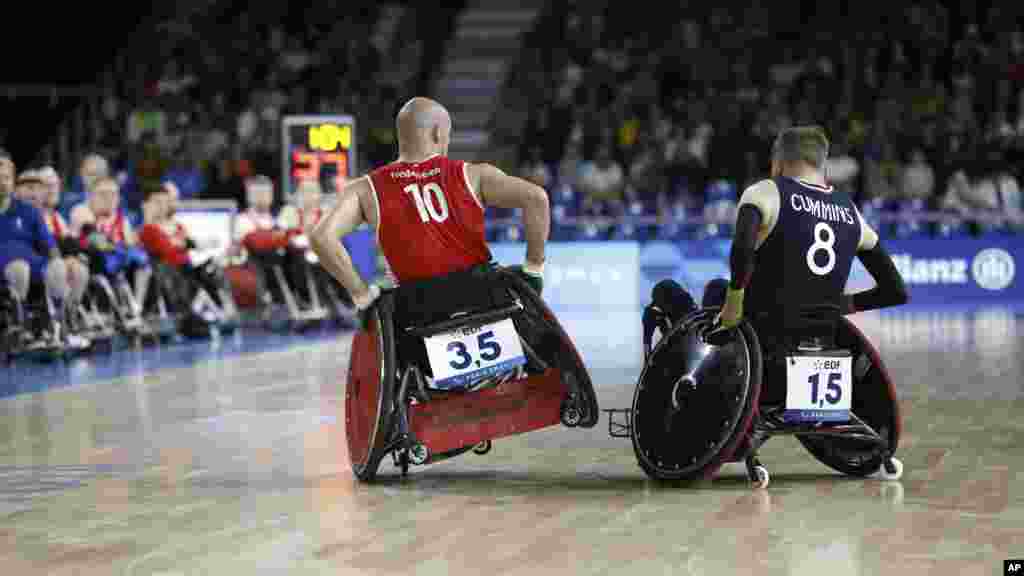 Denmark&#39;s Sebastian Frederiksen, left, makes contact with Britain&#39;s Nick Cummins during a preliminary-round wheelchair rugby match at the Paralympic Games in Paris.