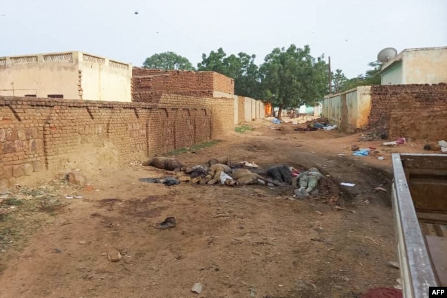 A picture taken on June 16, 2023, shows bodies strewn near houses in the West Darfur state capital amid ongoing fighting in war-torn Sudan.