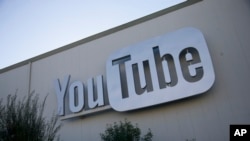 FILE - Signage is affixed at the YouTube Space offices in Los Angeles, Oct. 21, 2015. 