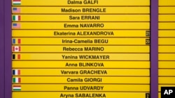 Part of a scoreboard shows players' names and their countries' flags, with Russian and Belarus flags omitted, on day one of the Wimbledon tennis championships near London, July 3, 2023.