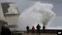 Waves crash over the harbor wall in Newhaven, southern England, Nov. 2, 2023. 