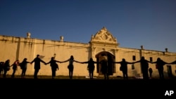 FILE - Women in support of the San Bernardo Convent's in support of the nuns who accused church officials of gender-based psychological and physical violence, in Salta, Argentina, May 3, 2022. 
