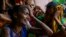 Family members of people trapped under rubble wail after a landslide washed away houses in Raigad, India, July 20, 2023. 