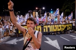 Protesters march through Tel Aviv in a protest against Israeli Prime Minister Benjamin Netanyahu and his nationalist coalition government's judicial overhaul, Sept. 17, 2023.