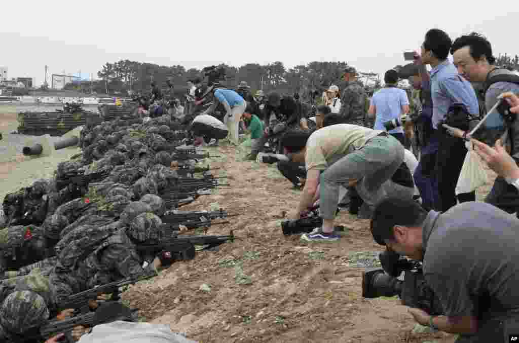 Medias film as South Korean Marines take positions after landing on the beach during the combined military amphibious landing exercise between South Korea and the U.S., called Ssangyong exercise, in Pohang.