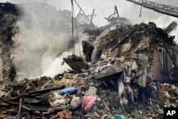 Rrescuers work at the scene of a building damaged by shelling, in Novogrodivka, Ukraine, Nov. 30, 2023. (Donetsk Regional Military Administration via AP)