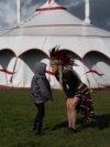 Ukrainian performer Julia Gorodetska speaks with her son Valdis, aged 7, outside Circus Cortex's big top tent during a break in a dress rehearsal of their show "Warriors" in Sheffield, England, on March 30, 2023. 