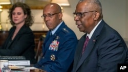 Defense Secretary Lloyd Austin, right, meets with Britain's Defense Secretary Grant Shapps, Jan. 31, 2024, at the Pentagon in Washington.