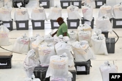 Seorang petugas pemilu menyiapkan kotak suara sebelum memulai penghitungan suara di Honiara, ibu kota Kepulauan Solomon, pada 18 April 2024, sehari setelah pemilu. (Foto: AFP)