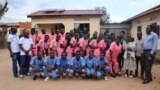 FILE - Students of Gubdue Health Science Institute, staff and tutors pose for a picture in front of the administration block of the Institute in Yambio, Western Equatoria State, South Sudan, Sept. 9, 2023. 