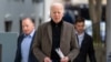 US President Joe Biden walks to speak with reporters as he leaves St. Edmund Roman Catholic Church in Rehoboth Beach, Del., Feb. 17, 2024, after attending a Mass.