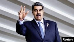 FILE - Venezuela's President Nicolas Maduro waves as he attends the South American Summit at Itamaraty Palace in Brasilia, Brazil, May 30, 2023.