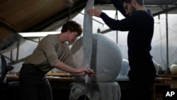 Artists create a globe at a studio in London, Feb. 27, 2024.