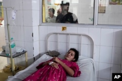 Neelam Tamar, 25, suffering from heat stroke, recovers at the Lalitpur district hospital, in Indian state of Uttar Pradesh, June 17, 2023.