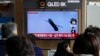 A TV screen shows a file image of North Korea's missile launch during a news program at the Seoul Railway Station in Seoul, South Korea, Feb. 14, 2024. 