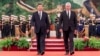 In this photo released by China's Xinhua News Agency, Chinese President Xi Jinping, left, and Cuba's President Miguel Diaz-Canel Bermudez walk during a welcome ceremony at the Great Hall of the People in Beijing, Nov. 25, 2022.
