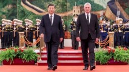 In this photo released by China's Xinhua News Agency, Chinese President Xi Jinping, left, and Cuba's President Miguel Diaz-Canel Bermudez walk during a welcome ceremony at the Great Hall of the People in Beijing, Nov. 25, 2022.