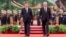 In this photo released by China's Xinhua News Agency, Chinese President Xi Jinping, left, and Cuba's President Miguel Diaz-Canel Bermudez walk during a welcome ceremony at the Great Hall of the People in Beijing, Nov. 25, 2022.