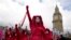 FILE - Activists protest outside the Houses of Parliament in London, April 21, 2023. Extinction Rebellion and other environmental groups are protesting for four days with an event they are calling 'The Big One'. 