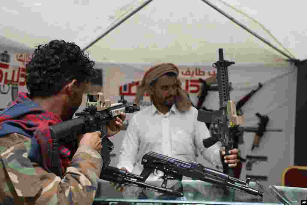 A man checks out an assault rifle at a gun store in a shopping mall in Sanaa, Yemen.