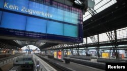 A digital board that reads 'no train service' is seen at the empty Cologne Central Station during a nationwide strike called by the EVG rail and transport union over a wage dispute, in Cologne, Germany, April 21, 2023.