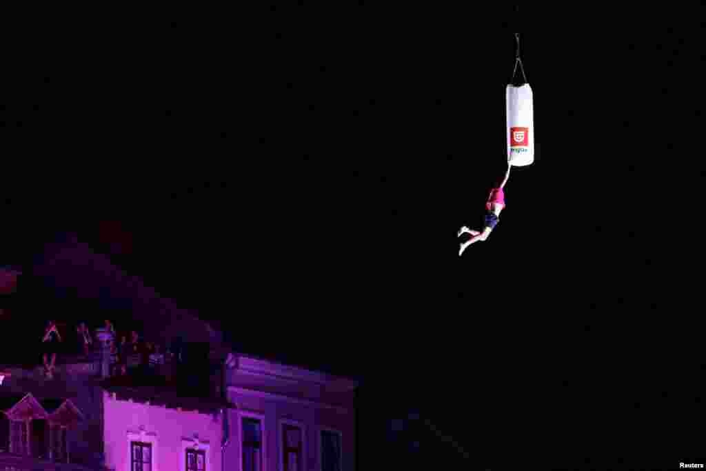 A man attempts to break the world record of the highest trampoline jump in Ljubljana, Slovenia, June 29, 2024. 